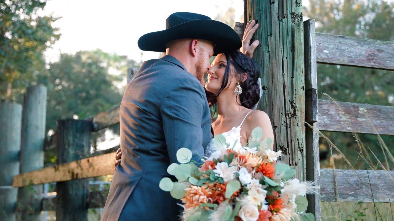 The Venue at Mudge Ranch Wedding Couple Fence